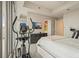Bright bedroom featuring an elliptical and city views at 1065 Peachtree Ne St # 2803, Atlanta, GA 30309