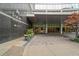 Loews Atlanta Hotel entrance featuring clean lines, stone accents, well-maintained landscaping, and covered entryway at 1065 Peachtree Ne St # 2803, Atlanta, GA 30309