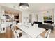 Open-concept living and dining area with views, modern lighting, and a stylish kitchen backdrop at 1065 Peachtree Ne St # 2803, Atlanta, GA 30309