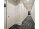 Well-lit hallway with carpet flooring, white walls, unit number, and clean design at 1065 Peachtree Ne St # 2803, Atlanta, GA 30309