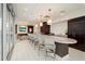 Gourmet kitchen boasts a large island, bar seating, and dark wood cabinets, perfect for entertaining at 1065 Peachtree Ne St # 2803, Atlanta, GA 30309