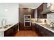 Contemporary kitchen with stainless steel appliances, granite countertops, and dark wood cabinets at 1065 Peachtree Ne St # 2803, Atlanta, GA 30309