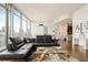 Living room with city views, modern lighting, sleek furniture, and open layout at 1065 Peachtree Ne St # 2803, Atlanta, GA 30309