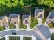 Aerial view of the houses in the neighborhood with nice landscaping, driveways, and lawns at 4568 Mantova Dr, Buford, GA 30519