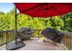 View of the back deck with two grills under a red umbrella, perfect for outdoor cooking at 4568 Mantova Dr, Buford, GA 30519