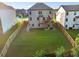 Spacious fenced backyard, showcasing the home's exterior and the back deck at 4568 Mantova Dr, Buford, GA 30519