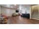 Large basement with wood flooring, television, couch, and plenty of space for entertainment at 4568 Mantova Dr, Buford, GA 30519