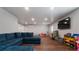 Spacious basement with TV, sectional sofa, hardwood floors, and ample room for activities at 4568 Mantova Dr, Buford, GA 30519