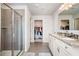 Bright bathroom with a glass shower, granite countertop vanity, and closet access at 4568 Mantova Dr, Buford, GA 30519
