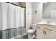 Bathroom featuring a shower-tub combo with curtain, updated vanity, and neutral color palette at 4568 Mantova Dr, Buford, GA 30519