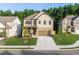 Charming two-story home featuring a stone facade, well-manicured lawn, and a welcoming front porch at 4568 Mantova Dr, Buford, GA 30519