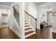 Entryway features hardwood flooring, staircase with iron balusters, and access to other rooms at 4568 Mantova Dr, Buford, GA 30519