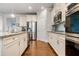 Modern kitchen with stainless steel appliances, granite countertops, and ample cabinet space at 4568 Mantova Dr, Buford, GA 30519