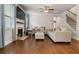 Open living room with hardwood flooring, fireplace, large windows, and neutral color scheme at 4568 Mantova Dr, Buford, GA 30519