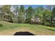Lush green backyard with mature trees providing privacy and a serene outdoor setting at 1015 Pebble Creek Trl, Suwanee, GA 30024