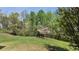 A spacious backyard featuring a lush lawn and mature trees offering both shade and natural beauty at 1015 Pebble Creek Trl, Suwanee, GA 30024