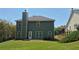 Exterior view of home with a well-maintained backyard and patio at 1015 Pebble Creek Trl, Suwanee, GA 30024