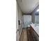 Bathroom featuring a shower-tub combo, wood-look floor, and modern fixtures at 1015 Pebble Creek Trl, Suwanee, GA 30024