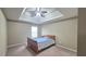 Bedroom with a bed, tray ceiling, and ceiling fan at 1015 Pebble Creek Trl, Suwanee, GA 30024