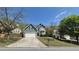 Charming two-story home featuring stone accents, vinyl siding, large driveway, and well-manicured lawn at 1015 Pebble Creek Trl, Suwanee, GA 30024