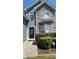 The house features a charming front entrance with stone accents and manicured landscaping at 1015 Pebble Creek Trl, Suwanee, GA 30024