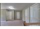 Upstairs hallway with multiple closets and neutral carpet; ideal for storage and organization at 1015 Pebble Creek Trl, Suwanee, GA 30024