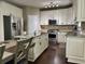 This kitchen features a large island, stainless appliances, granite countertops, and white cabinets at 1015 Pebble Creek Trl, Suwanee, GA 30024