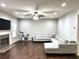 Spacious living room with fireplace, modern furnishings, a ceiling fan, and recessed lighting at 1015 Pebble Creek Trl, Suwanee, GA 30024