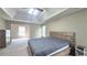 Spacious main bedroom with tray ceiling, ceiling fan, and adjoining room at 1015 Pebble Creek Trl, Suwanee, GA 30024