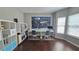 Bright office featuring a map of the world, hardwood floors, and white shelving at 1015 Pebble Creek Trl, Suwanee, GA 30024