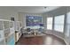 Bright office featuring a map of the world, hardwood floors, and white shelving at 1015 Pebble Creek Trl, Suwanee, GA 30024