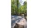 A wooden deck and railing provide an excellent view of the surrounding trees and greenery at 1084 Whistle Dr, Austell, GA 30106