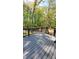 Wooden deck with a view of a wooded landscape, accessible by a set of stairs at 1084 Whistle Dr, Austell, GA 30106