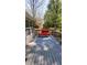 A shaded back deck with a red couch, designed for relaxation and outdoor enjoyment at 1084 Whistle Dr, Austell, GA 30106