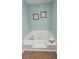 Corner bathtub in bathroom with tile flooring and framed artwork on the walls at 1084 Whistle Dr, Austell, GA 30106
