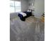 Cozy bedroom featuring carpet floors, a comfortable bed, and a bright window at 1084 Whistle Dr, Austell, GA 30106