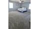 Large bedroom with plush gray carpet, ceiling fan, and two windows for ample natural light at 1084 Whistle Dr, Austell, GA 30106