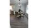 Elegant dining area with modern lighting and views into the kitchen at 1084 Whistle Dr, Austell, GA 30106