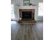 Close-up of the brick fireplace with white mantle and decorative accents at 1084 Whistle Dr, Austell, GA 30106