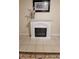 White ornamental fireplace with electric insert and tile floors at 1084 Whistle Dr, Austell, GA 30106