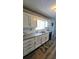 Modern kitchen featuring white cabinets, granite countertops, and stainless steel appliances at 1084 Whistle Dr, Austell, GA 30106
