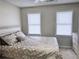 Cozy bedroom featuring neutral walls, carpeted floors, two windows with blinds, and a comfortable-looking bed at 128 Brookhaven Ln, Mcdonough, GA 30253