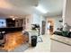 Bright kitchen featuring white cabinetry, granite counters, and stainless steel appliances with a view into the living room at 128 Brookhaven Ln, Mcdonough, GA 30253