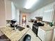 Well-lit kitchen showcasing white cabinets, granite countertops, stainless steel appliances, and recessed lighting at 128 Brookhaven Ln, Mcdonough, GA 30253