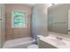 Bathroom with a shower-tub combo, large window, and sink at 4684 City View Dr, Forest Park, GA 30297