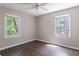 Cozy bedroom featuring a ceiling fan, hardwood flooring, and a view to the outdoors at 4684 City View Dr, Forest Park, GA 30297
