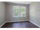 A bright bedroom featuring hardwood floors and a window with natural light at 4684 City View Dr, Forest Park, GA 30297