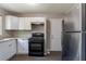 Open kitchen design with stainless steel appliances and neutral finishes for a move-in ready experience at 4684 City View Dr, Forest Park, GA 30297
