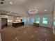 Spacious living room and kitchen combo featuring modern lighting, island, and lots of natural light at 500 Level Creek Rd, Sugar Hill, GA 30518