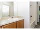 Bright bathroom with a single sink, wooden cabinet, and shower at 5880 Trent Walk Dr, Lithonia, GA 30038